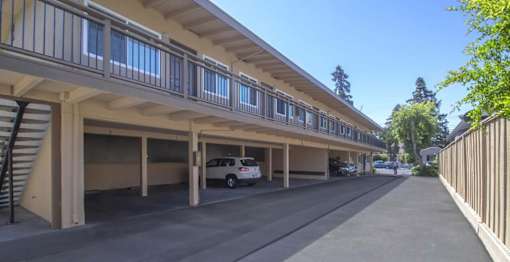 a parking lot with a car parked under a building