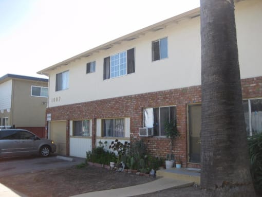 Side view of the white and brick apartment community aProdesse Property Group 1007 Leigh AvenueSan Jose, CA 95128