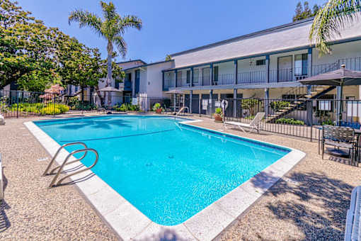 A swimming pool in front of a house.