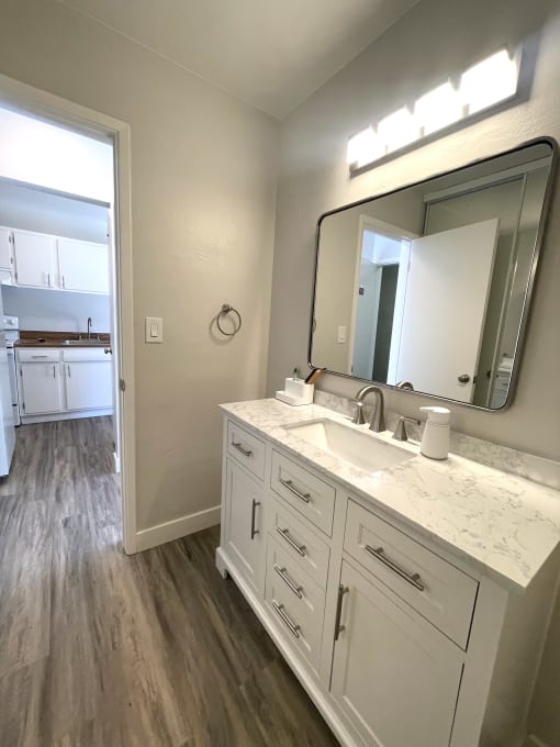 an empty bathroom with a sink and a mirror