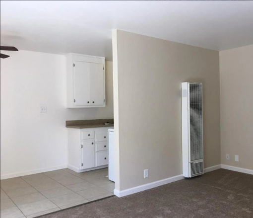 The interior of  1007 Leigh Ave San Jose, CA 95128 the view of the living room heater and the entrance to the kitchen