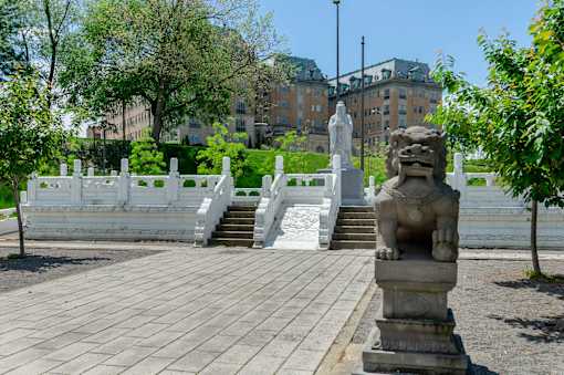 Lounge area for residents, fitted with a paved walkway, stairway, and statues at Park Lane Villa.