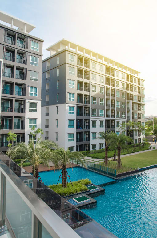 the view from the balcony of an apartment building with a swimming pool