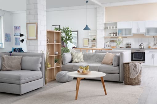 a living room and kitchen with couches and a coffee table