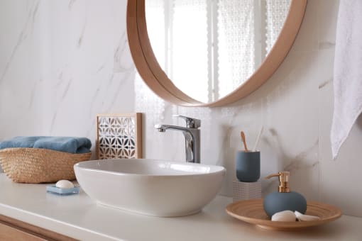 a bathroom with a sink and a mirror and a window