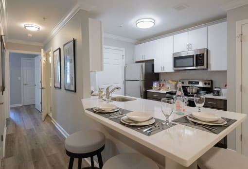 a kitchen with a large island with a breakfast bar