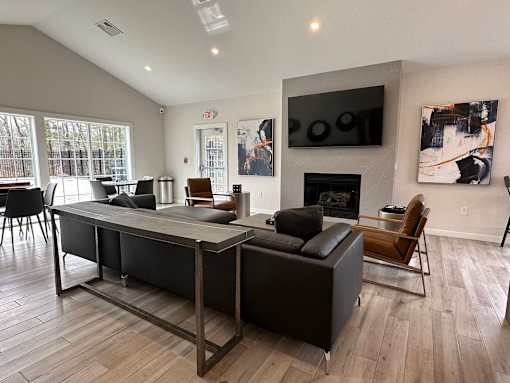 A modern living room with a fireplace and a television.