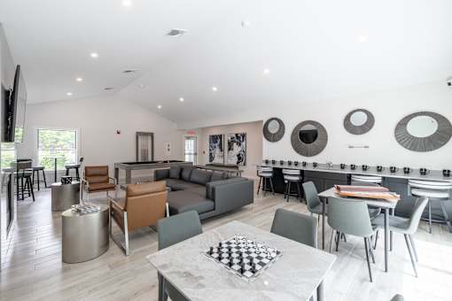 A modern living room with a checkered table in the middle.