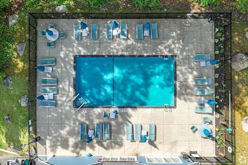 An aerial view of a swimming pool surrounded by lounge chairs.