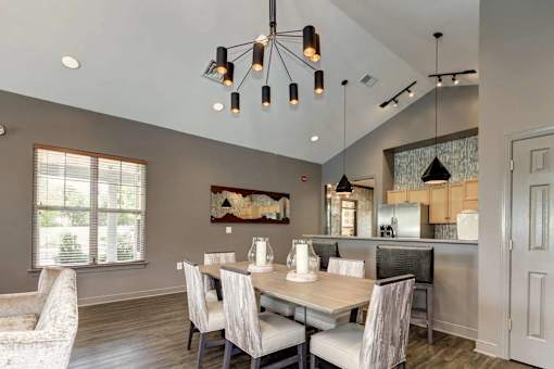 A modern dining room with a wooden table and chairs.