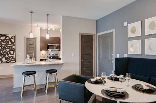 Modern kitchen with a bar area and a dining table at Caldwell, Houston
