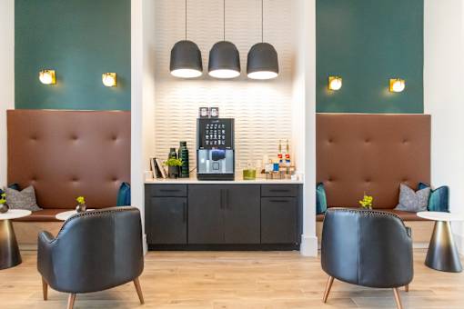 A modern cafe with brown booths and black chairs.