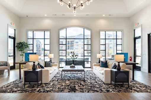 A large, well-lit room with a rug, two couches, and a coffee table.