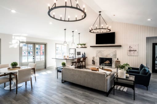 clubhouse lounge with couches and chairs and a fireplace at Addison on Cobblestone, Fayetteville, GA