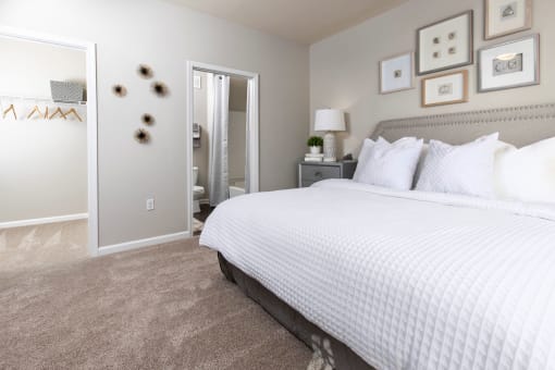 a bedroom with a large bed and a closet at Ansley at Town Center in Evans GA