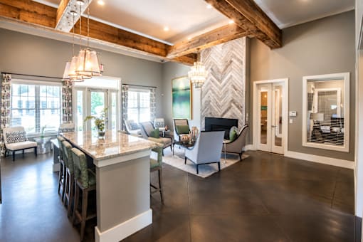 A modern kitchen with a large island and bar stools.