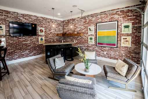 A living room with a brick wall and a fireplace.