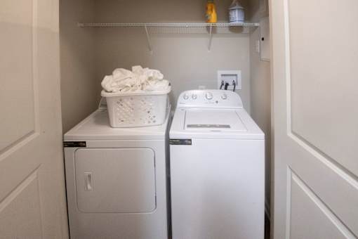 A small laundry room with a washer and dryer.