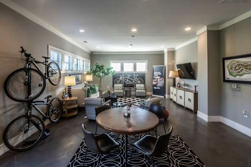A living room with a bicycle leaning against the wall.