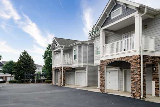A row of townhouses with garages and balconies.