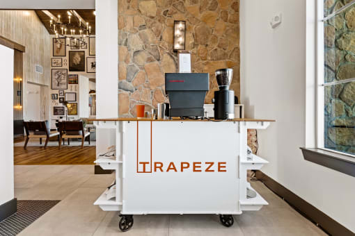a coffee cart in the lobby of a coffee shop with a coffee machine on it