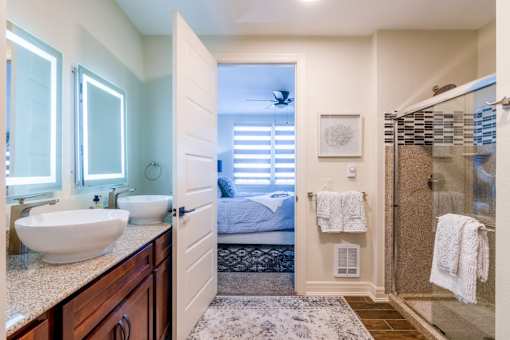 A bathroom with a white sink and a mirror above it.at Carson Street Towers, Kansas