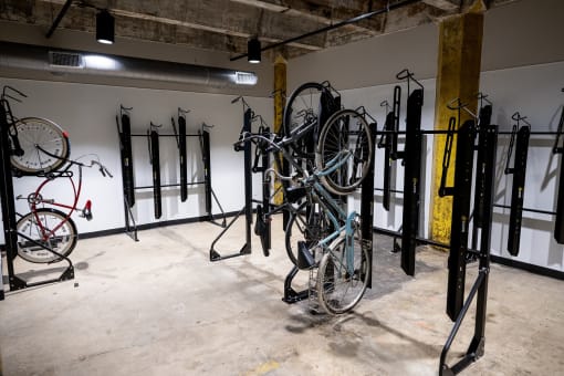 a bike rack with several bikes hanging on it