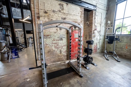 a gym with a brick wall and a red door in the background