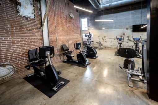 a fitness center with treadmills and elliptical machines