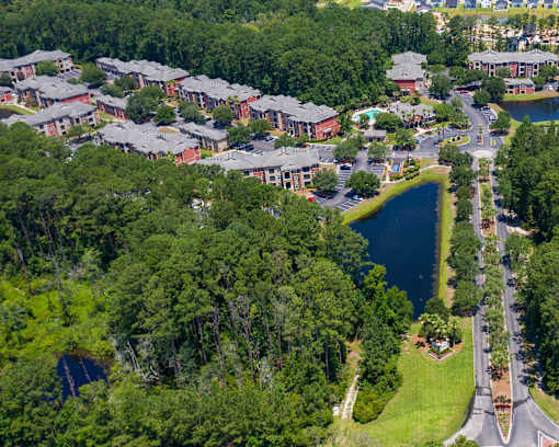 Aerial view of apartment community with pond and landscaping at Courtney Bend Apartments, Hardeeville, SC