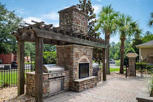 Outdoor fireplace and grilling station with pergola at Courtney Bend Apartments, South Carolina, 29927