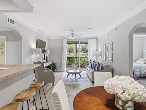 Open concept living room with balcony access at Courtney Bend Apartments, Hardeeville, SC 29927