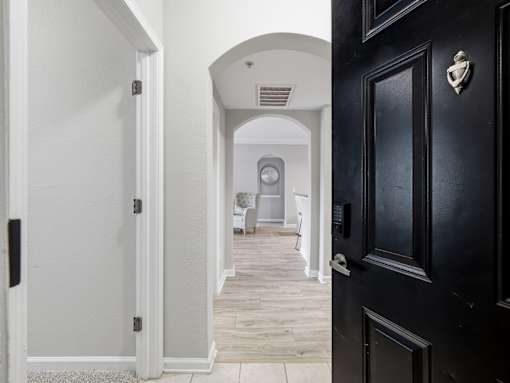 Entryway with arched hallway and hardwood style flooring at Courtney Bend Apartments, Hardeeville, SC