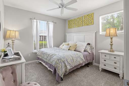 Bedroom with white furniture and ceiling fan at Courtney Bend Apartments, Hardeeville, SC