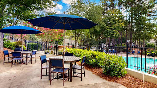 Patio with tables and chairs at Creekside at White Oak, Georgia