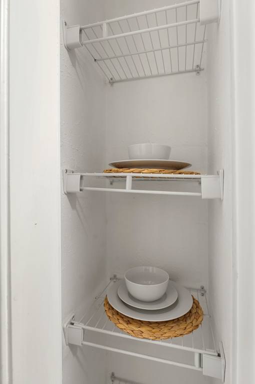 A white refrigerator with a bowl and a plate on the shelf. at Dunwoody Glen, Atlanta Georgia