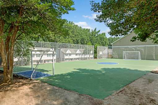 A tennis court surrounded by trees at Dunwoody Glen, Atlanta, GA