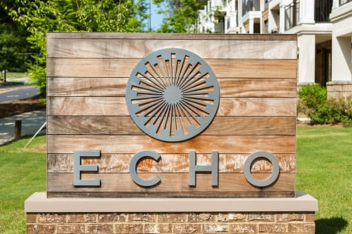 Lush landscaping surrounds you as you drive into Echo at North Pointe Center Apartment Homes, Alpharetta, GA 30009