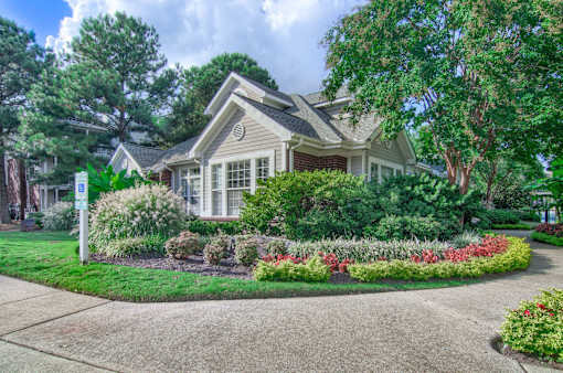 A house with a well-maintained garden in front at Enclave at Wolfchase Apartments, Memphis, TN 38016