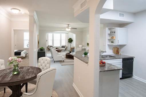 A modern kitchen with a dining table and chairs.