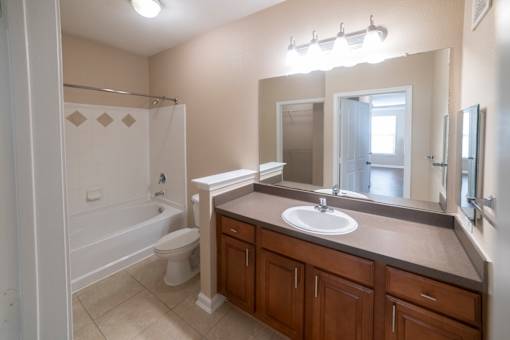 A bathroom with a white toilet and a white sink.