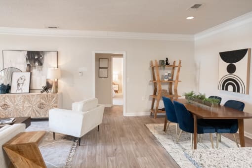 a living and dining room area with a wooden table and blue chairs at Appling Lakes, Cordova, Tennessee