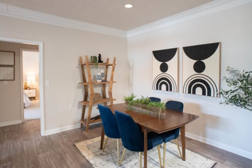 a dining room with a wooden table and blue chairs at Appling Lakes, Cordova, TN, 38016