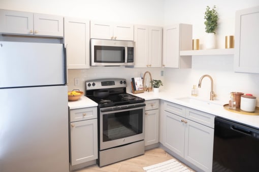 a kitchen with white cabinets and stainless steel appliances at Appling Lakes, Cordova, TN, 38016