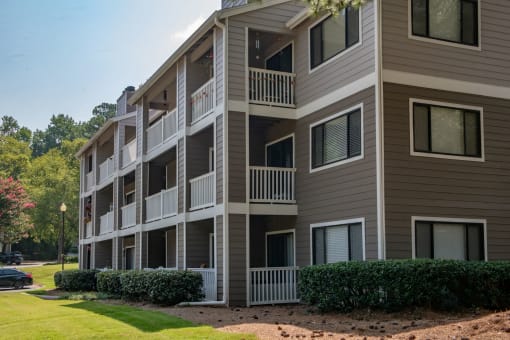an exterior view of an apartment building on a sunny day