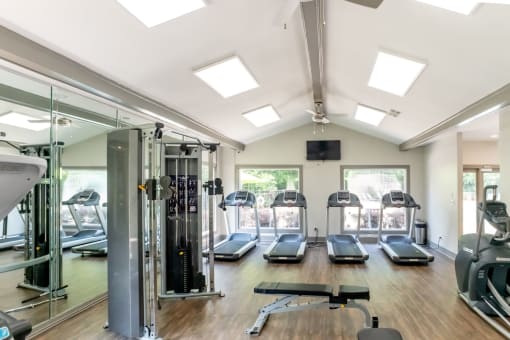 a gym with treadmills and other exercise equipment and windows at 1900 Rosemont, Roswell, 30076