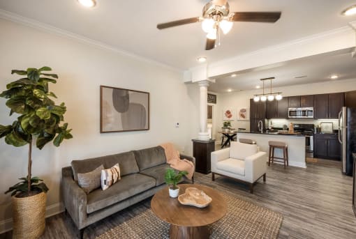 a living room with a couch and a table at Arlo Luxury homes Apartments, Little Rock, AR,72210
