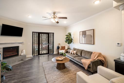 a living room with a couch and a fireplace at Arlo Luxury homes Apartments, Little Rock