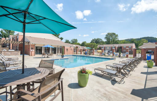 our apartments offer a swimming pool with tables and chairs at Brightwaters Apartments, Little Rock