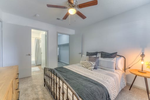 a bedroom with a bed and a ceiling fan at Brightwaters Apartments, Little Rock, 72202
